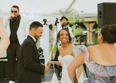 Bride and groom dancing in front of rented stage