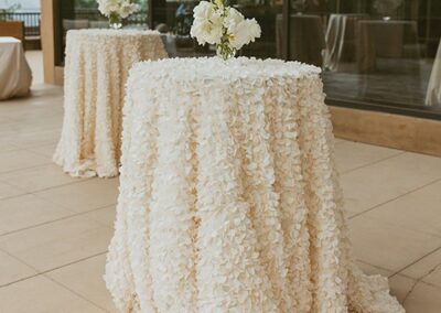 Elegant floral linens covering cocktail tables at styled shoot