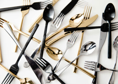 Flatlay of black, gold and silver forks and spoons