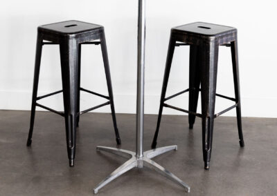 Simple cocktail table with black bar stools