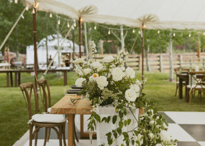 Wedding setup with tent, floor and tabletop rentals in a simple spring black and white theme from Gallatin Event Rental