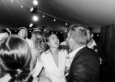 Couple singing and dancing under tent